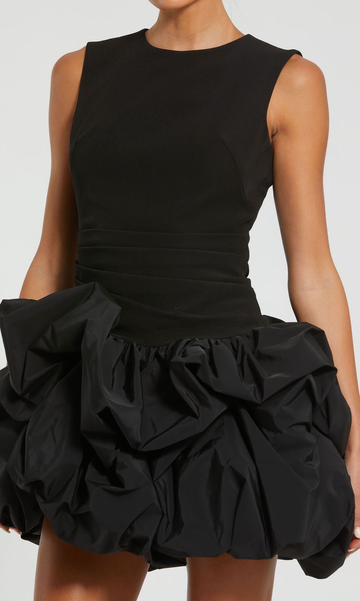 A woman in the Mac Duggal 20709 Short Black Bubble Party Dress, featuring a sleeveless fitted bodice and mini bubble skirt—perfect for parties.